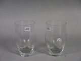 two empty glasses sitting on a white surface