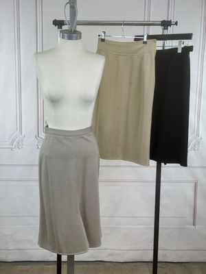 two skirts on a mannequin stand in a room
