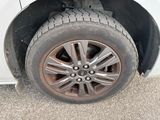 a close up of a tire on a white car