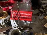 a pile of empty glasses and boxes on the floor