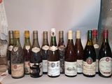 many bottles of wine lined up on a table