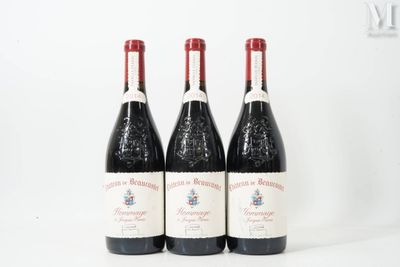 three bottles of red wine sit on a white surface