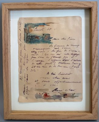 une vieille lettre manuscrite est exposée dans un cadre en bois