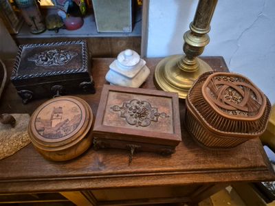 a wooden table with a lamp, a box, and other items on it