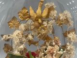 a glass clochet with a bunch of flowers inside of it