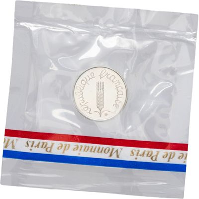 la pièce se trouve dans un sachet en plastique orné d'une bande rouge, blanche et bleue