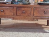 a wooden table with two fish bowls on top of it