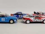 three toy cars are lined up in a row on a white surface