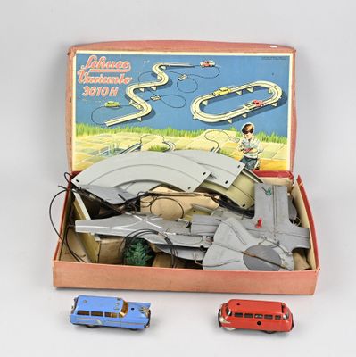 a box with a toy train set and a toy car in it