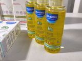 three bottles of hand sanitizer sitting on a table next to a box of soap