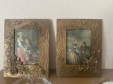 two framed pictures of a woman and a child on a table