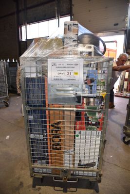 a man standing next to a cart with a lot of items in it