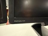 a computer monitor sitting on top of a desk next to a keyboard