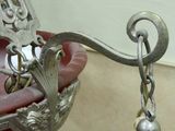 a pair of earrings hanging from a hook on a wall