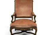 an old chair with a brown upholstered seat and a brown upholstered cushion