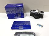 the camera is sitting on the table next to the box