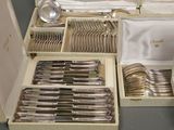 a lot of silverware in a box on the table