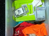 a plastic container filled with assorted items on the floor