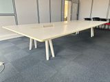 a long table with two chairs in the middle of the room