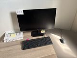 a computer desk with a keyboard, mouse, and monitor