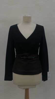 black long sleeved top with belt on a mannequin base