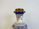 a blue and white vase sitting on a table
