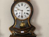 two clocks on the wall that are hanging on the wall
