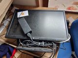 a laptop computer sitting on top of a desk next to a blue chair