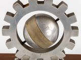 a metal sculpture with a clock on top of it