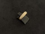 a close up of a gold ring with diamonds on a black surface