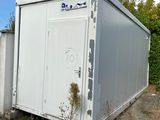 a white container sitting on the side of the road