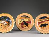three plates with a picture of a horse and a man on a horse