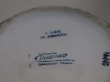 a close up of a white plate with blue writing on it