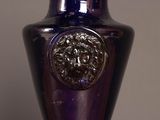 a purple vase with a lion head on it