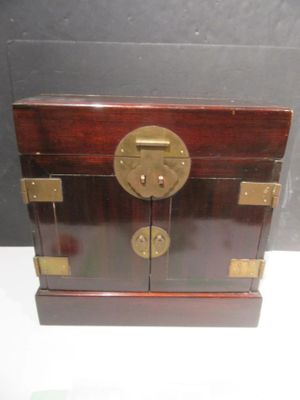 a small wooden box with a brass lock on it