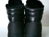 pair of black leather boots with black fur lined on them