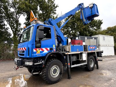 a blue crane that is parked in a parking lot