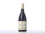 a bottle of wine sitting on top of a white table