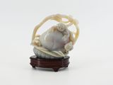 chinese carved ivory figurine of a baby in a basket on a stand