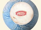 a blue and white ball with a red and white label on it