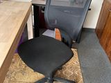 a desk with a chair and a computer on it