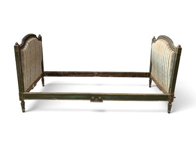a bed that has a wooden frame and headboard on it