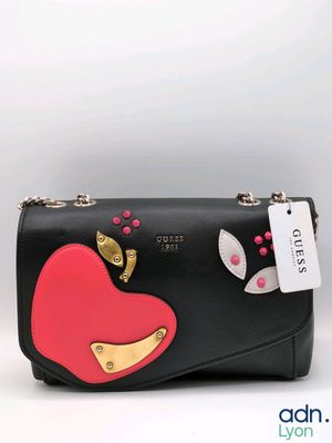 a black purse with a red heart on it