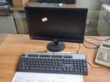 a desk with a keyboard, mouse, and monitor on it