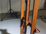 a wooden stand with a clock on it in a room