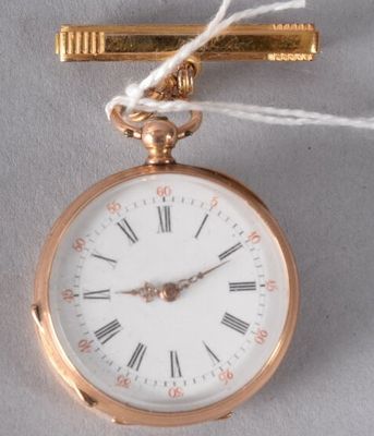 a gold pocket watch with a tie bar attached to it