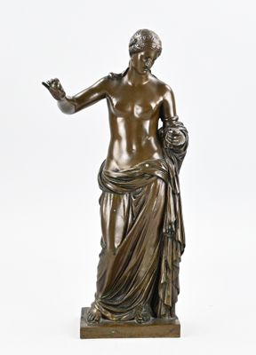 an antique bronze statue of a woman holding a flower