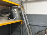 a ladder that is next to a shelf with pots and pans on it