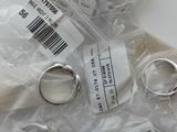 a lot of silver rings in a bag on a table
