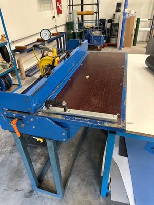 an image of a machine that is cutting a piece of wood